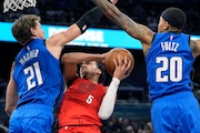 Orlando Magic center Moritz Wagner (21) fouls Portland Trail Blazers guard Dalano Banton (5) as he goes up for a shot past guard Markelle Fultz (20) during the first half of an NBA basketball game, Monday, April 1, 2024, in Orlando, Fla. (AP Photo/John Raoux) AP
