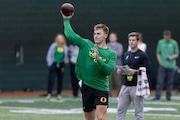 Oregon quarterback Bo Nix throws over the middle as the Ducks hold their annual pro day in front of NFL scouts at the Moshofsky Center in Eugene, Oregon on Tuesday, March 12, 2024. 