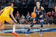 UConn guard Paige Bueckers sets up the offense with USC guard JuJu Watkins defending as the Huskies face the Trojans in the Elite Eight of the NCAA women’s tournament at the Moda Center in Portland, Oregon on Monday, April 1, 2024.