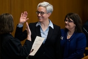 Tina Kotek (center) was accompanied by her wife Aimee Wilson (right) as Kotek was sworn in as Oregon governor at the state capitol building in Salem, OR on Mon., Jan. 9, 2022. Dave Killen / The Oregonian