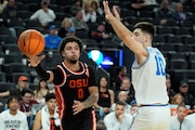 Oregon State guard Jordan Pope (0) passes around UCLA guard Lazar Stefanovic (10) during the second half of an NCAA college basketball game in the first round of the Pac-12 tournament Wednesday, March 13, 2024, in Las Vegas. (AP Photo/John Locher)