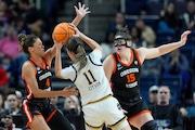 Notre Dame guard Sonia Citron (11) looks to pass against Oregon State guard Donovyn Hunter (4) and forward Raegan Beers (15) during the second quarter of a Sweet Sixteen round college basketball game during the NCAA Tournament, Friday, March 29, 2024, in Albany, N.Y. (AP Photo/Mary Altaffer)