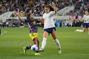 United States forward Alex Morgan, right, clears the ball next to Colombia forward Manuela Pavi, left, during the first half of a CONCACAF Gold Cup women's soccer tournament quarterfinal, Sunday, March 3, 2024, in Los Angeles. (AP Photo/Marcio Jose Sanchez)