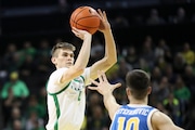 Oregon guard Brennan Rigsby (4) shoots over UCLA guard Lazar Stefanovic (10) during the first half of an NCAA college basketball game in Eugene, Ore., Saturday, Dec. 30, 2023. (AP Photo/Amanda Loman)