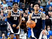 Gonzaga's Malachi Smith (13) and Julian Strawther (0) celebrate in the second half of a Sweet 16 college basketball game against UCLA in the West Regional of the NCAA Tournament, Thursday, March 23, 2023, in Las Vegas. (AP Photo/David Becker)