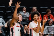 Guard Dexter Akanno (4) and forward Jayden Stevens (14) of the Oregon State Beavers react on the sidelines after a successful three-point shot was made during the second half of the season opener basketball game against the Linfield Wildcats on Monday, Nov. 6, 2023, at Gill Coliseum in Corvallis.