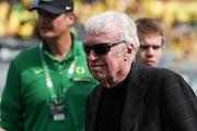 Nike founder Phil Knight walks on the field before an NCAA football game between Colorado and Oregon, Saturday, Sept. 23, 2023, in Eugene, Ore. Oregon won 42-6. (AP Photo/Amanda Loman)