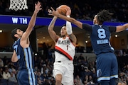 Portland Trail Blazers guard Anfernee Simons (1) looks to shoot between Memphis Grizzlies forwards Santi Aldama (7) and Ziaire Williams (8) in the first half of an NBA basketball game Friday, March 1, 2024, in Memphis, Tenn. (AP Photo/Brandon Dill) AP