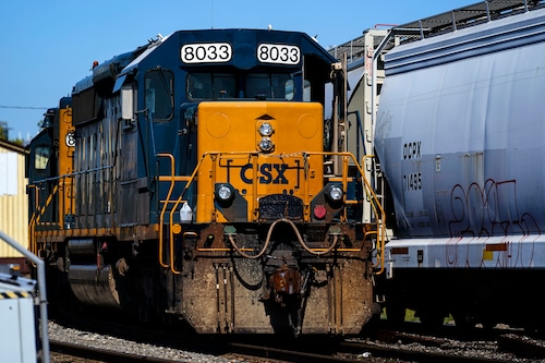 A CSX train engine sits idle on tracks