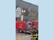 A man swung from a communication wire strung across West Sixth Street for 45 minutes before falling onto a Vancouver Fire engine on Sat., March 23, 2024.