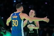 Golden State Warriors guard Stephen Curry and New York Liberty guard Sabrina Ionescu. (AP Photo/Darron Cummings)