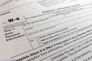 FILE - A W-4 form on Feb. 5, 2020, in New York. Monday is Tax Day, the federal deadline for individual tax filing and payments. The IRS will receive tens of millions of filings electronically and through paper forms. (AP Photo/Patrick Sison, File)
