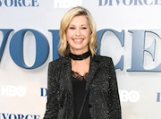 FILE - In this Oct. 4, 2016 file photo, actress and singer Olivia Newton-John attends the premiere of HBO's "Divorce" in New York. Newton-John says she has breast cancer and is canceling her June tour. The 68-year-old singer announced Tuesday, May 30, 2017, that she initially thought she was suffering from back pain, but learned it was “breast cancer that has metastasized to the sacrum.” (Photo by Andy Kropa/Invision/AP, File)