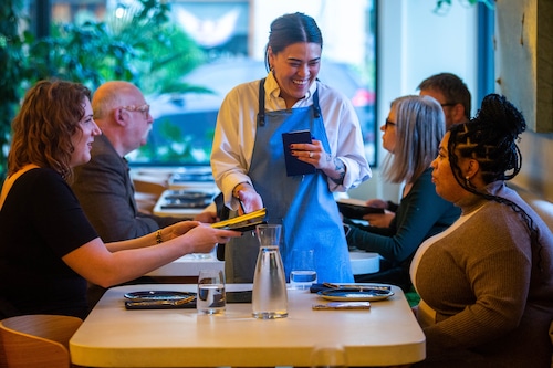 Server speaks with two diners