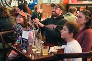 Vida Fleischauer, left, cheers on Princeton women’s basketball with her father, Seth Fleischauer, middle left, at The Sports Bra in Portland, Oregon on Friday, March 17, 2023.