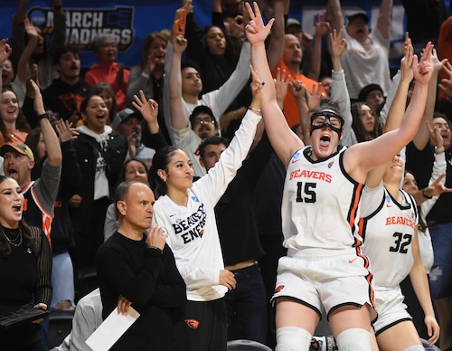Oregon State forward Raegan Beers (15) celebrates a 3-point basket from the bench next to head coach Scott Rueck, left, during the second half of a second-round college basketball game in the women's NCAA Tournament against Nebraska in Corvallis, Ore., Sunday, March 24, 2024. Oregon State won 61-51. (AP Photo/Mark Ylen)