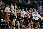 Oregon State players storm the floor after the Beavers beat Baylor 60-57 and secure a Final Four berth in 2016.