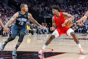 Portland Trail Blazers guard Scoot Henderson (#00) dribbles against Markelle Fultz of the Orlando Magic during an NBA basketball game at Moda Center in Portland, Oregon on Friday, Oct. 27, 2023.