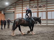 Sarah House atop a Clydesdale during an equestrian vaulting class at Forward Stride in Washington County.