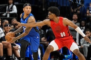 Orlando Magic guard Markelle Fultz, left, looks to pass the ball as he is pressured by Portland Trail Blazers guard Scoot Henderson (00) during the first half of an NBA basketball game, Monday, April 1, 2024, in Orlando, Fla. (AP Photo/John Raoux) AP