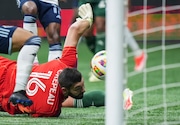 Portland Timbers goalkeeper Maxime Crepeau watches as the ball enters the net for a goal off the foot of Vancouver Whitecaps' Ryan Raposo during the second half of an MLS soccer match, in Vancouver, British Columbia, on Saturday, March 30, 2024. (Darryl Dyck/The Canadian Press via AP)